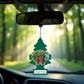 Royal Pine scented car air freshener hanging from rearview mirror inside a vehicle with forest road background