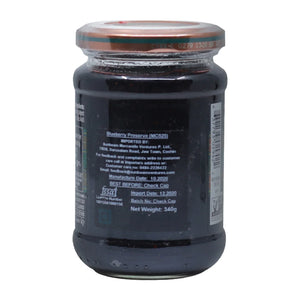 Glass jar of blueberry preserve with metal lid and label detailing import and manufacture information