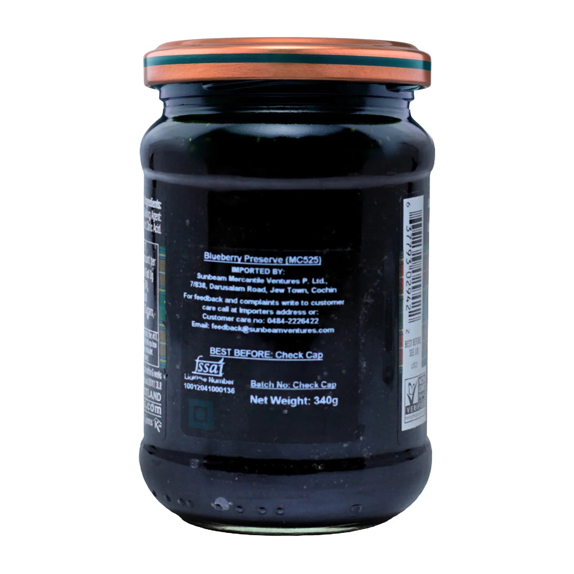 Back view of a glass jar of blueberry preserve showing product label and nutritional details