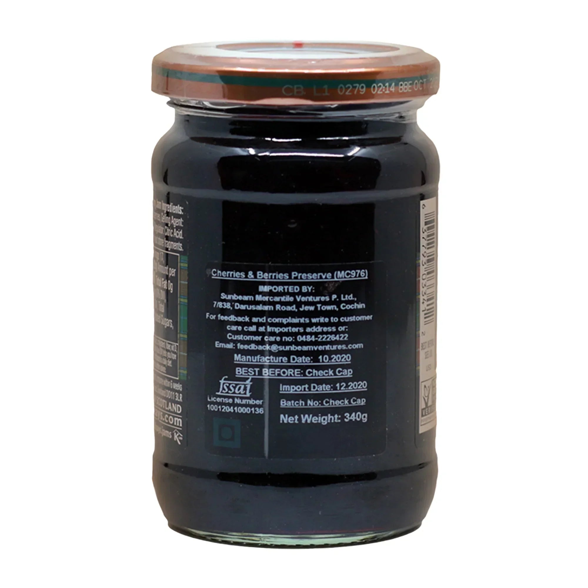 Jar of cherries and berries preserve with copper lid and detailed import and manufacturing labels