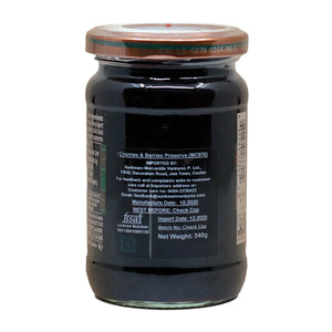 Jar of cherries and berries preserve with copper lid and detailed import and manufacturing labels