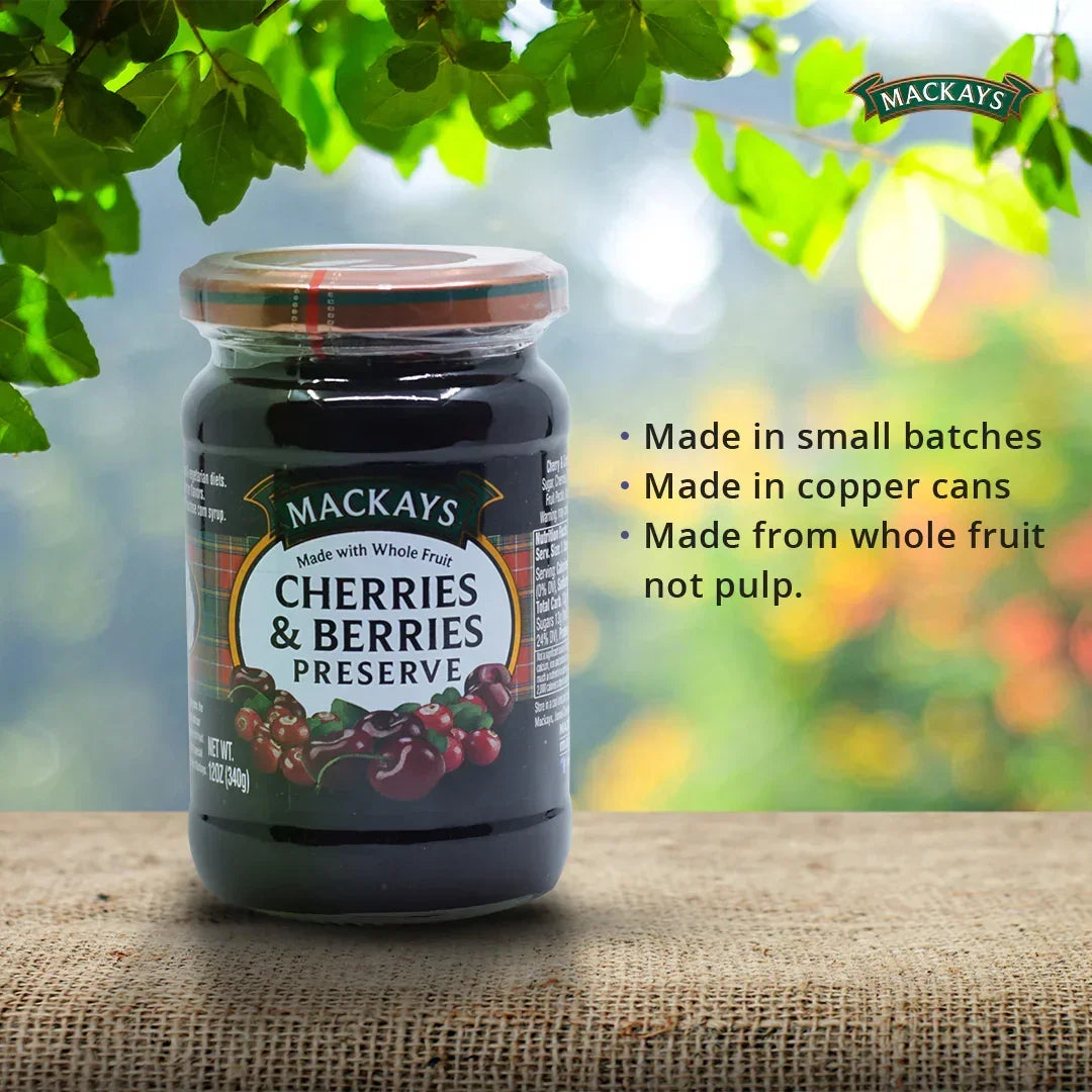 Mackays cherries and berries preserve jar on burlap with green leaves and product features