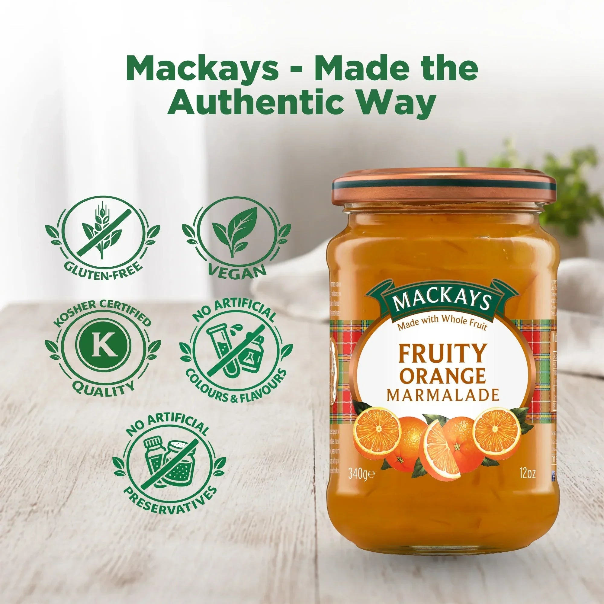 Mackays Fruity Orange Marmalade jar on table with gluten-free, vegan, kosher, no artificial colours or preservatives icons.