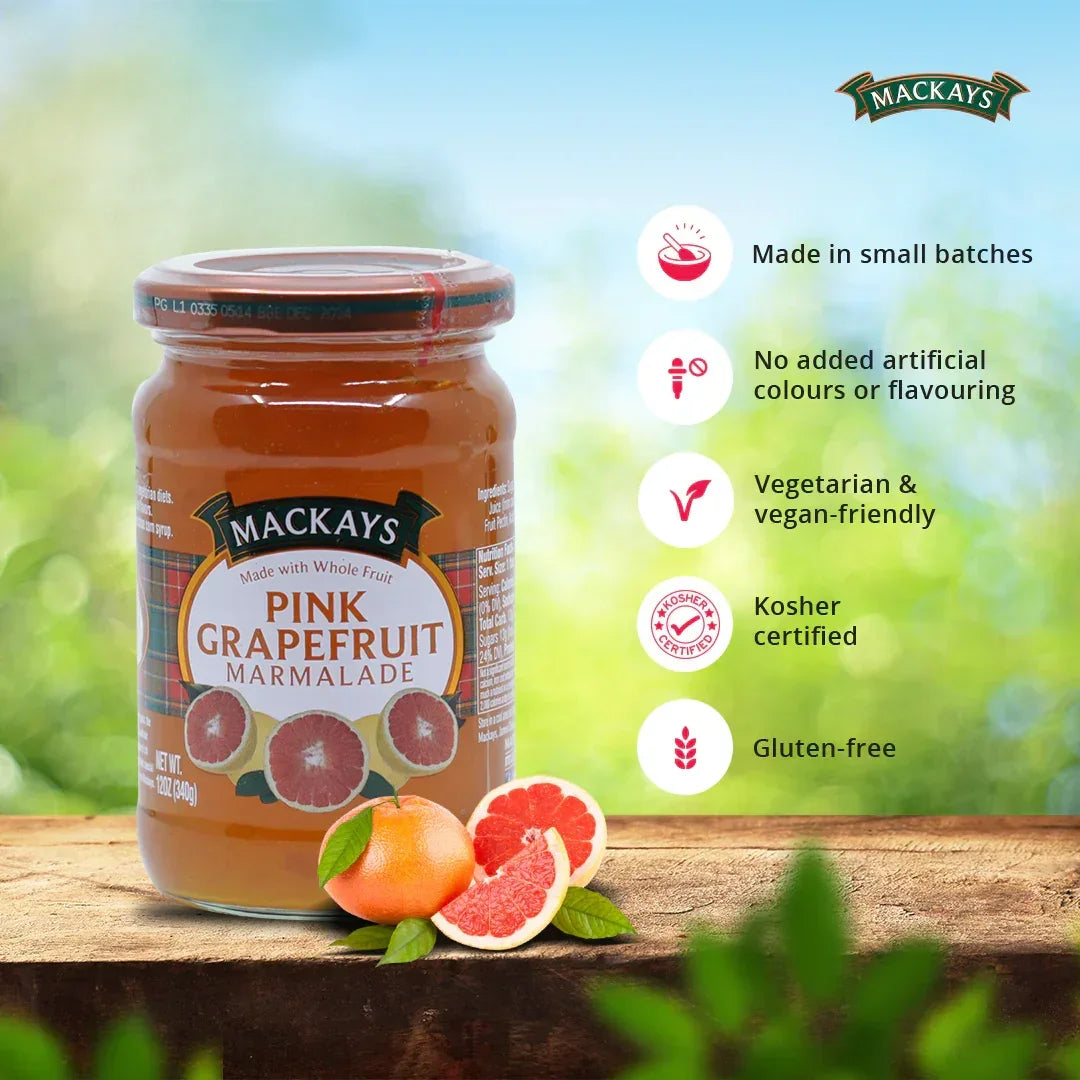 Mackays Pink Grapefruit Marmalade jar on wooden surface with fresh grapefruit halves and product benefits listed