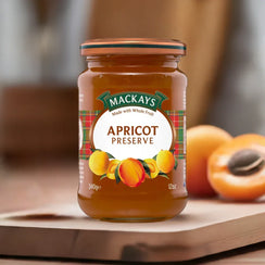 Mackays Scottish Apricot Preserve jar with tartan label and fresh apricots on wooden surface