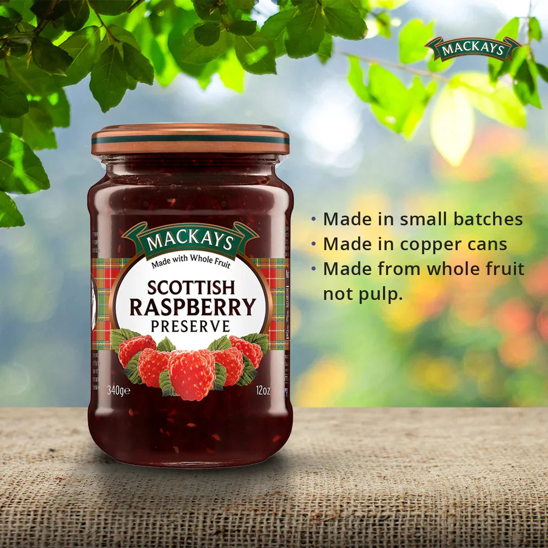 Jar of Mackays Scottish Raspberry Preserve on rustic fabric with green foliage background and product highlights