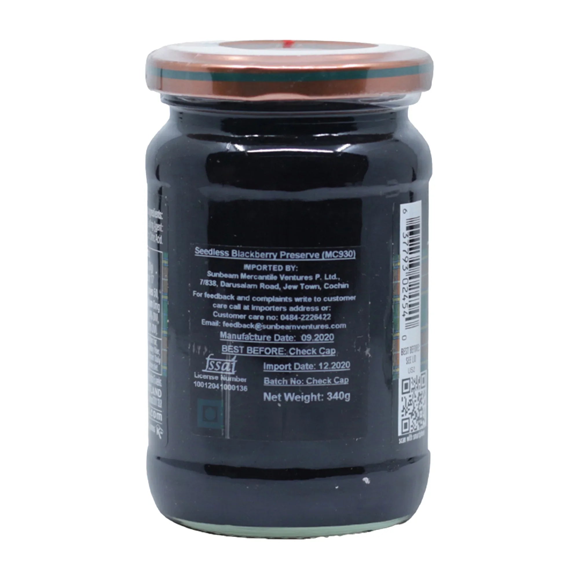 Sealed jar of seedless blackberry preserve with nutrition and import details on the label