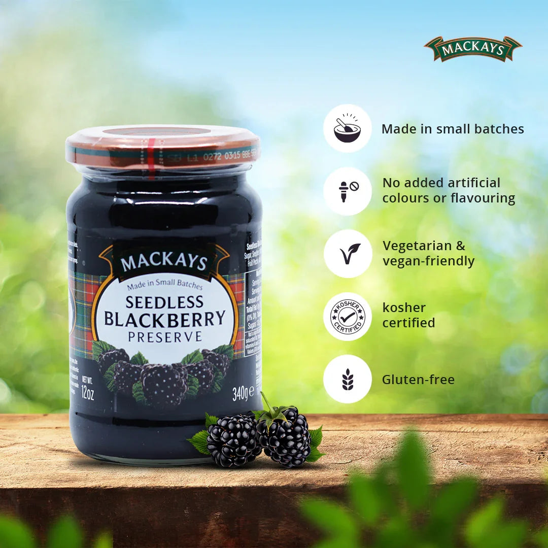 Jar of Mackays Seedless Blackberry Preserve with fresh blackberries on wooden surface and product benefits