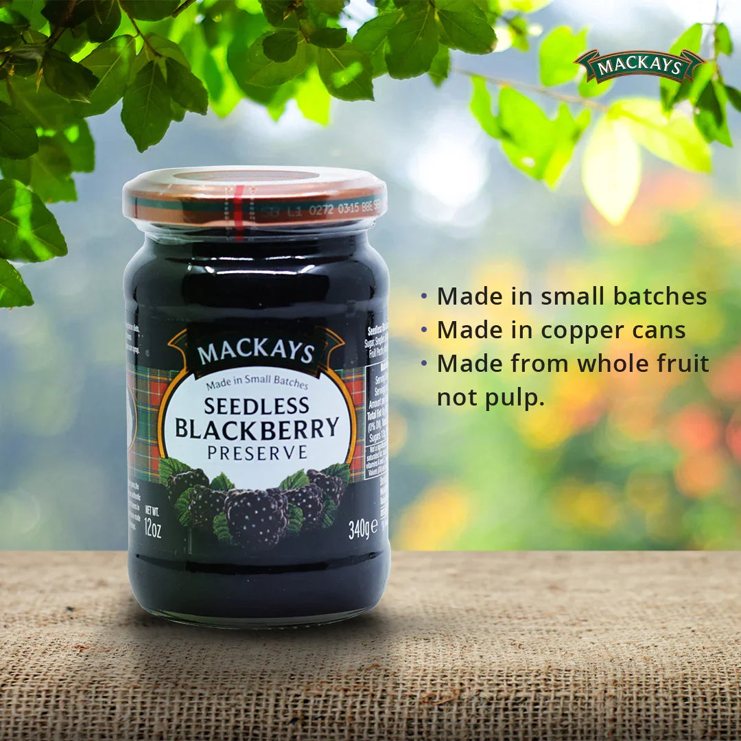 Mackays Seedless Blackberry Preserve jar on burlap with natural green leafy background and product features