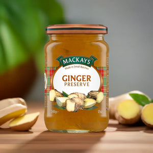 Jar of Mackays Ginger Preserve with fresh ginger roots on wooden surface