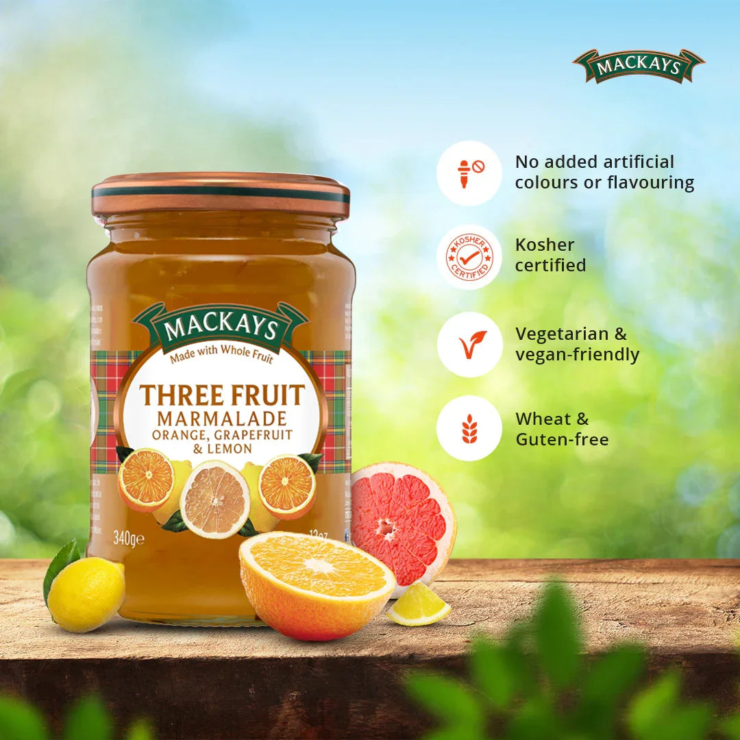 Jar of Mackays Three Fruit Marmalade with orange, grapefruit, and lemon on wood surface, vegan and gluten-free