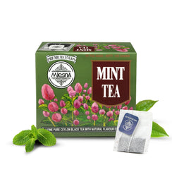 Green box of mint tea with floral design, tea bag, and fresh mint leaves visible