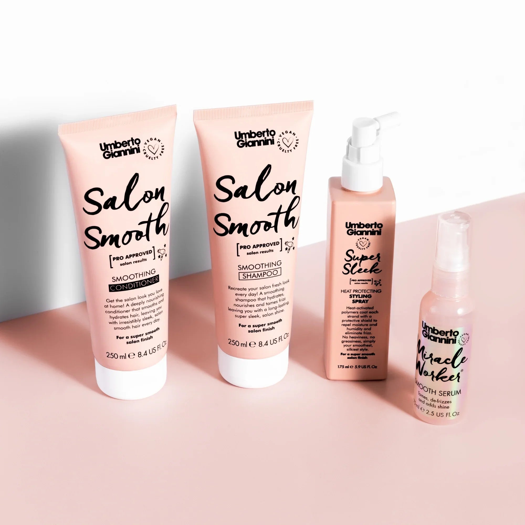 Umberto Giannini Salon Smooth hair care set including smoothing conditioner, shampoo, heat protect spray, and Miracle Worker serum on pink background