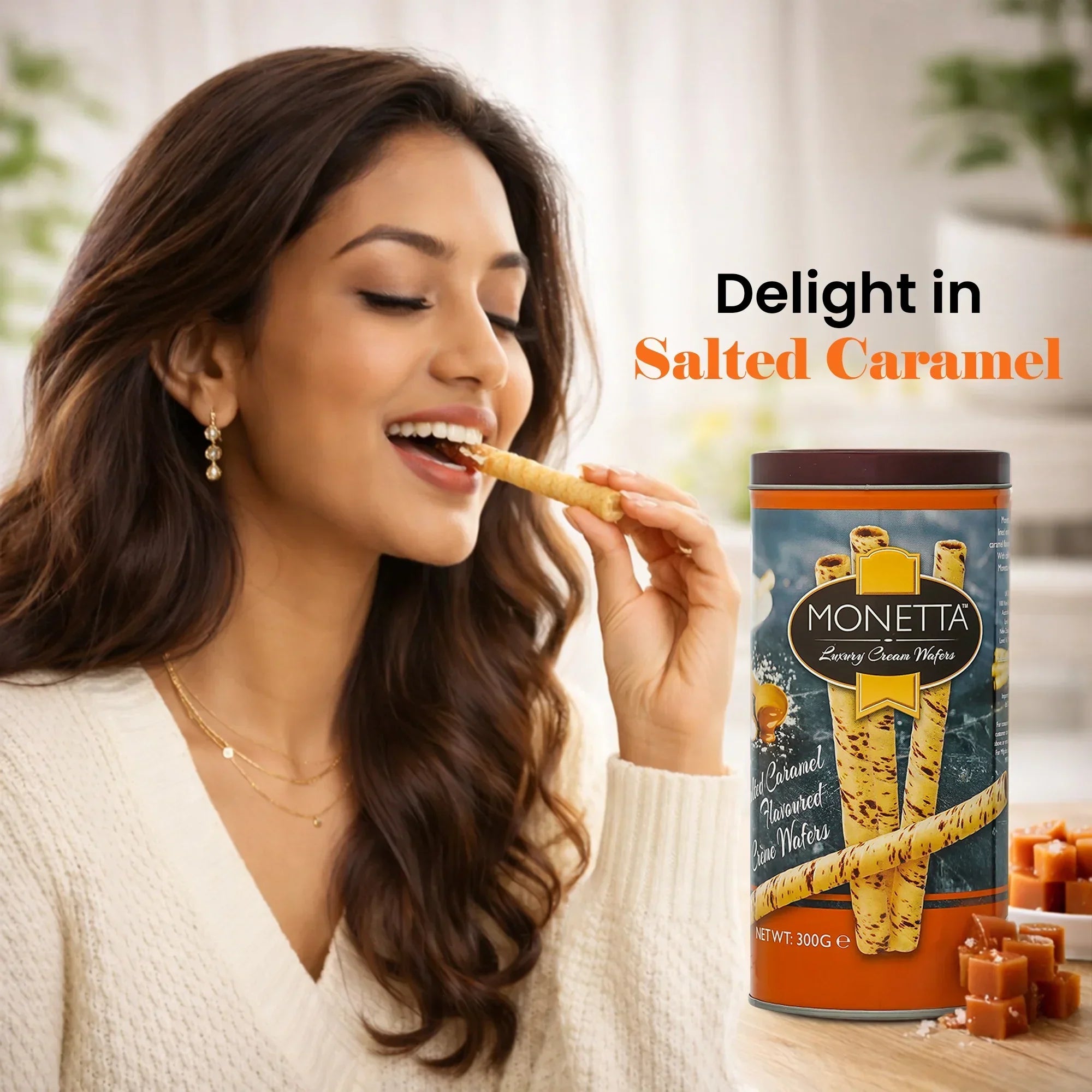 Woman enjoying salted caramel cream wafer stick with Monetta tin and caramel pieces