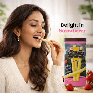 Woman enjoying strawberry cream wafer stick with Monetta wafer tin and strawberries