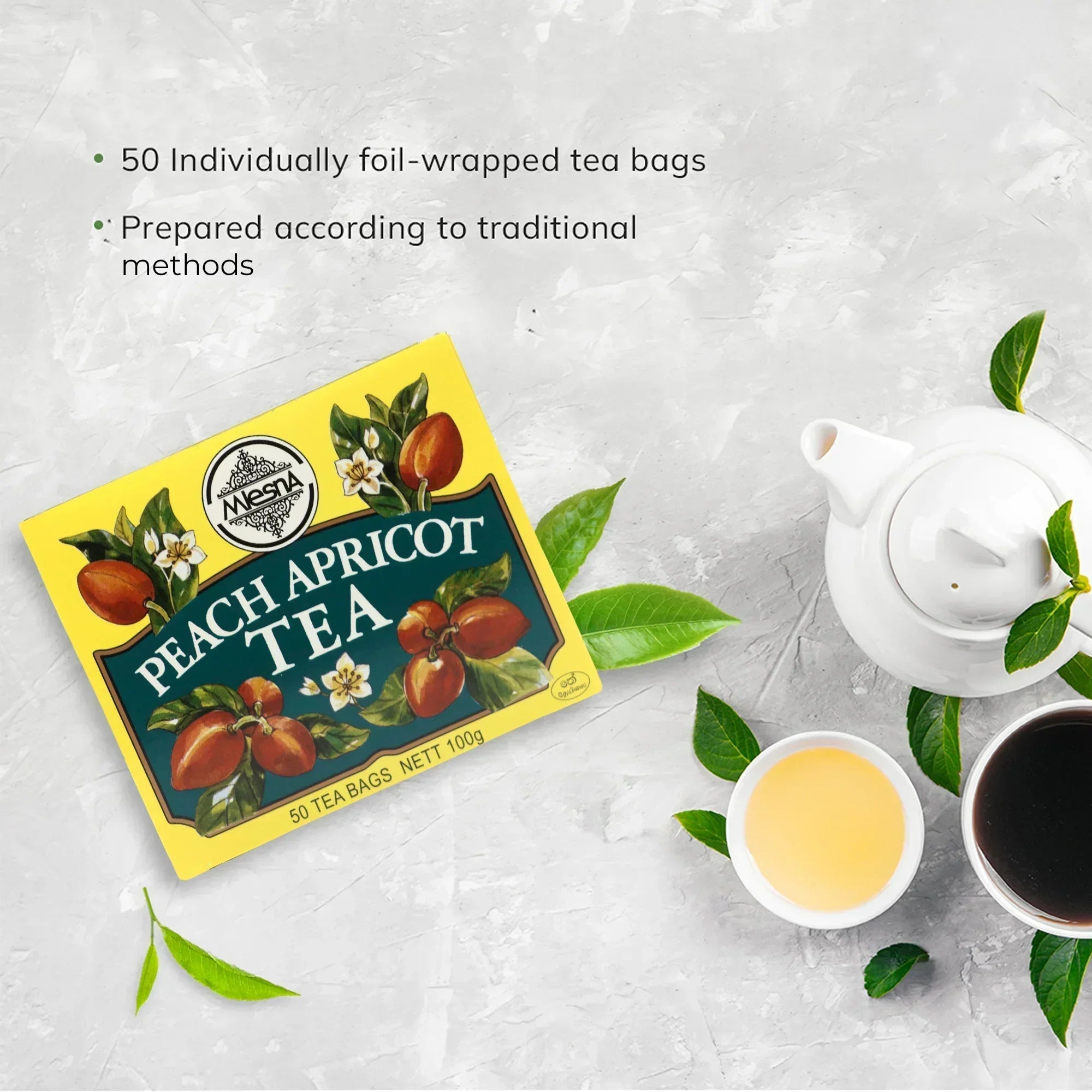 Peach apricot tea box with 50 tea bags, teapot, two tea cups, and tea leaves on a light background