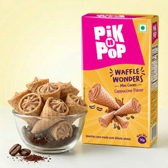 Cappuccino flavored mini waffle cones in a glass bowl with product packaging, coffee beans, and powder.