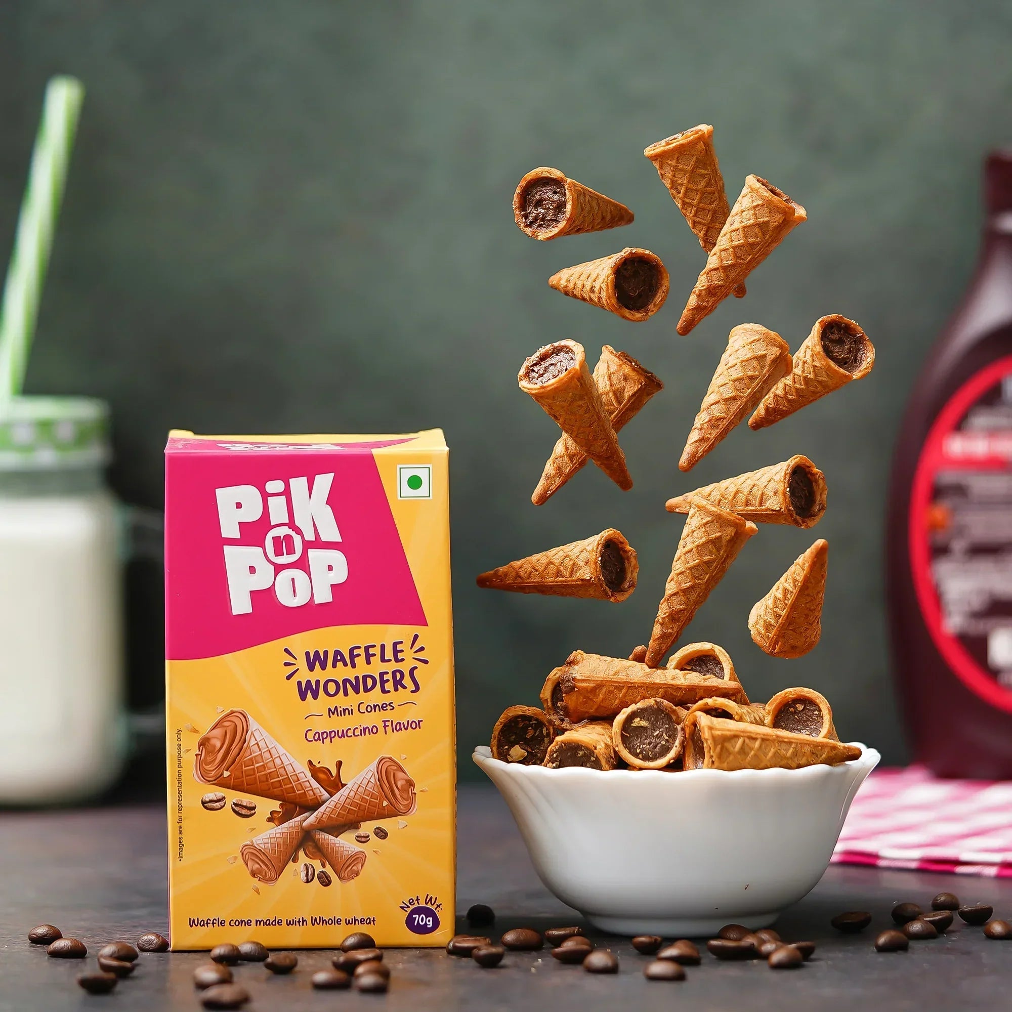 Pik n Pop waffle wonders mini cappuccino cones in a bowl with packaging, milk, and coffee beans