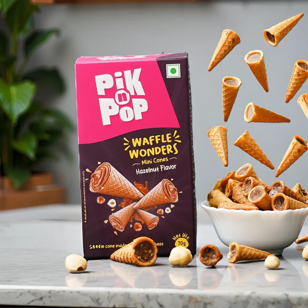 Pik n Pop Waffle Wonders hazelnut mini cones box with scattered cones and hazelnuts on marble surface