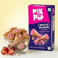Strawberry mini waffle cones in a glass bowl beside Pik n Pop Waffle Wonders strawberry flavor box.