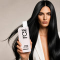 Woman with long black hair holding a bottle of ICE Professional Repair My Hair Shampoo.
