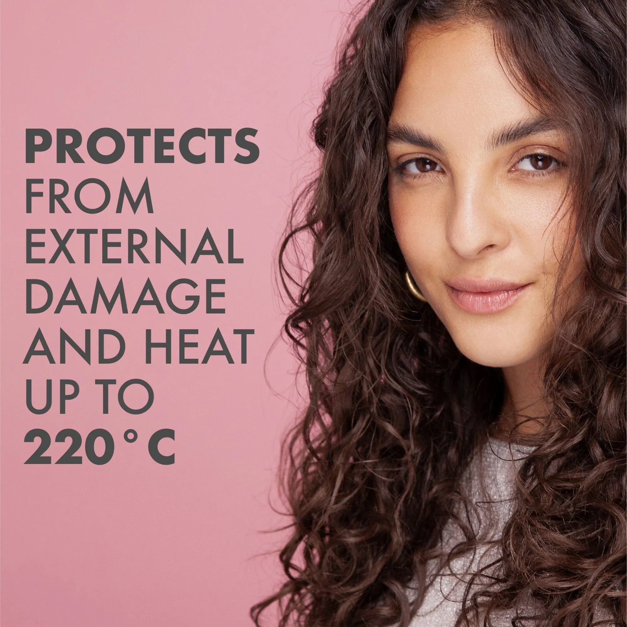 Close-up of a woman with long curly hair against a pink background, text says protects from external damage and heat up to 220°C