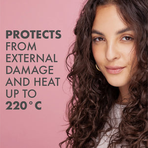 Close-up of a woman with long curly hair against a pink background, text says protects from external damage and heat up to 220°C