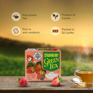 Strawberry green tea box, fresh strawberries, and glass cup of tea on wooden surface