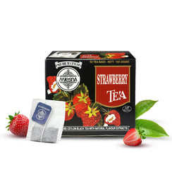 Strawberry tea box with fresh strawberries, tea bags, and green tea leaves