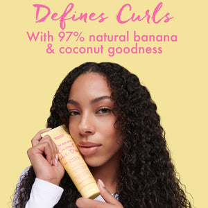 Curly-haired woman holding yellow Umberto Giannini Banana Coconut Air Dry Styling Cream with text about 97% natural banana and coconut ingredients